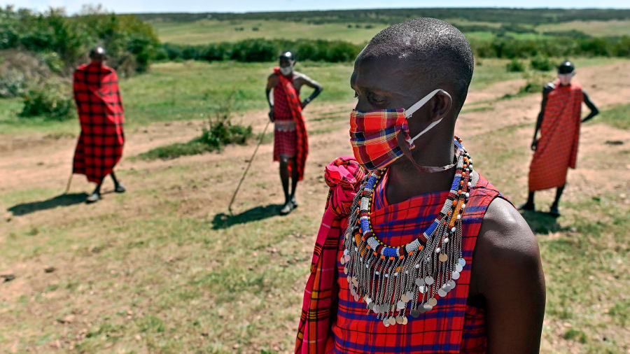 Maasai people socially distanced and wearing face masks